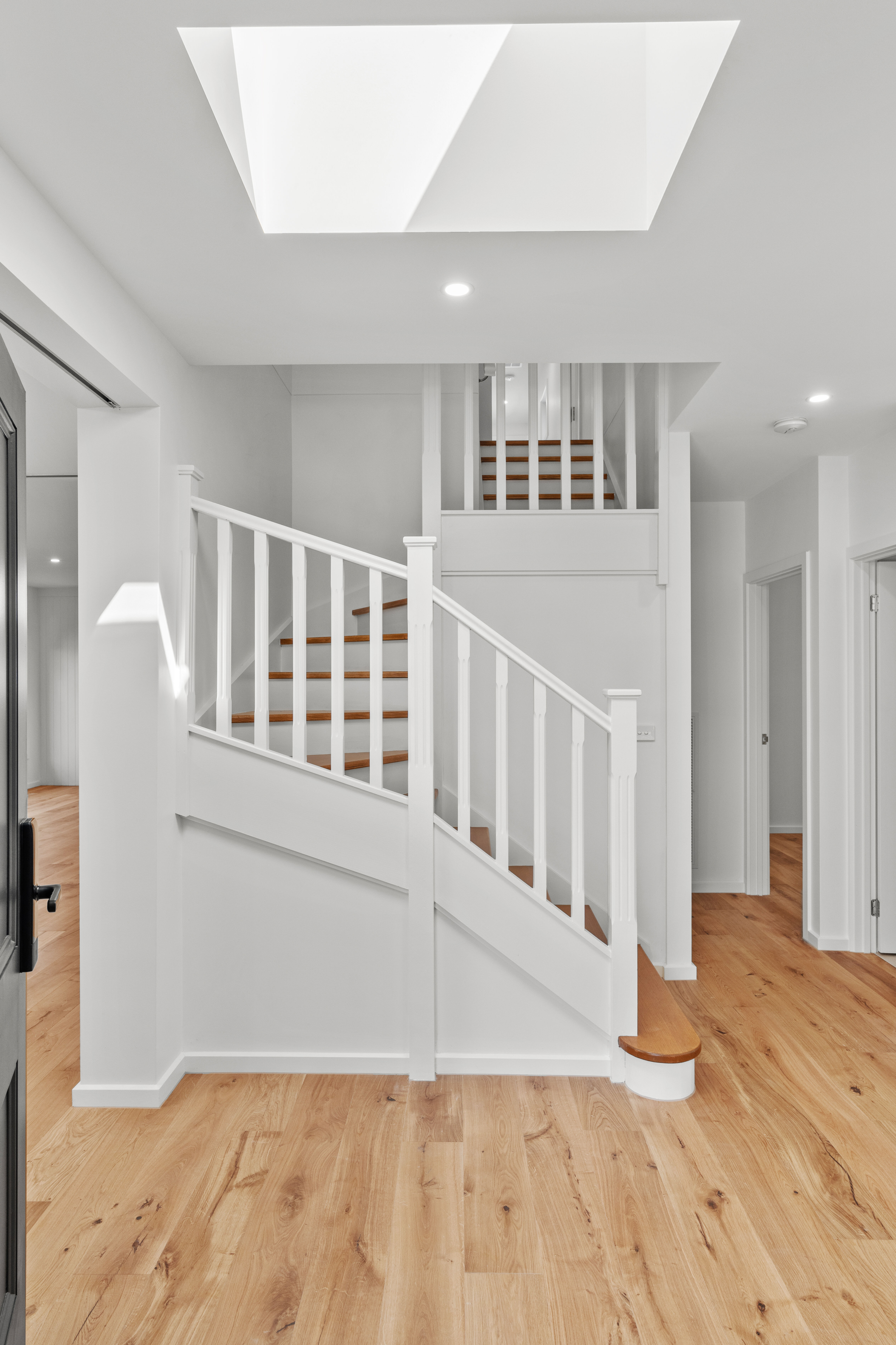 White staircase balustrade with skylight