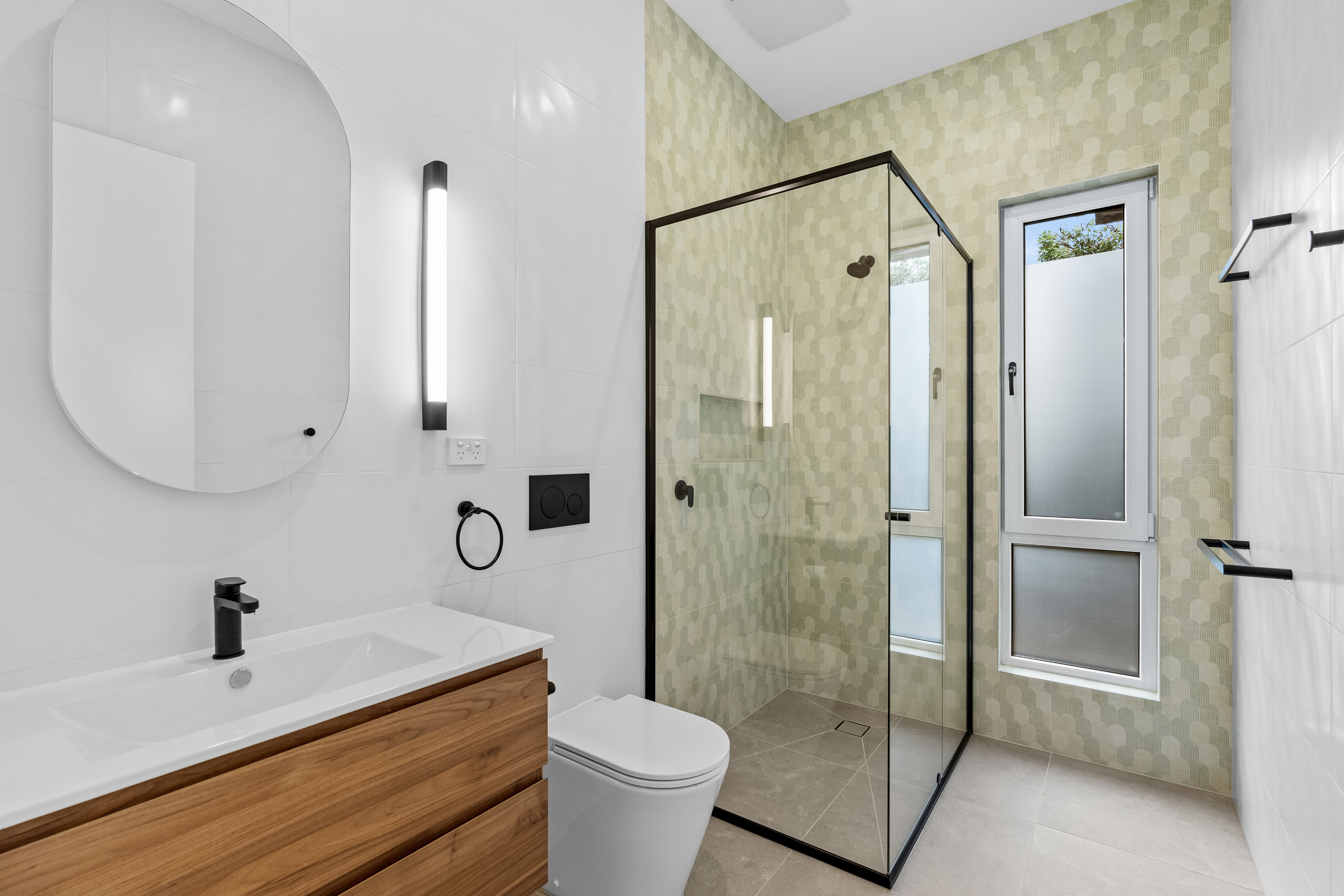 Bathroom with feature green tiles