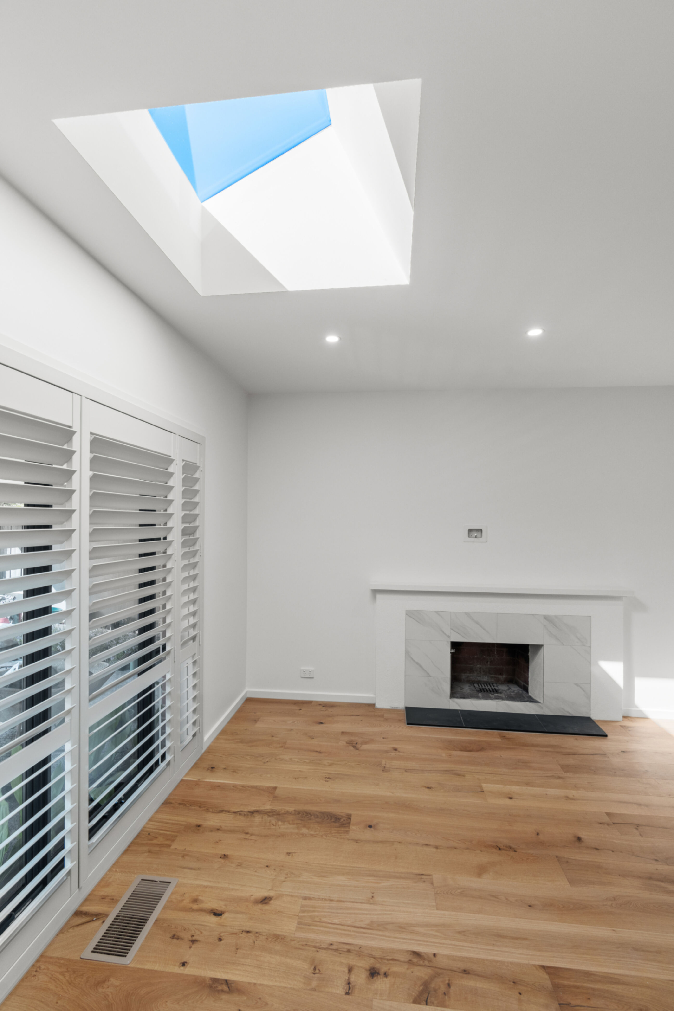 Living room with fireplace and Vivid Skylight