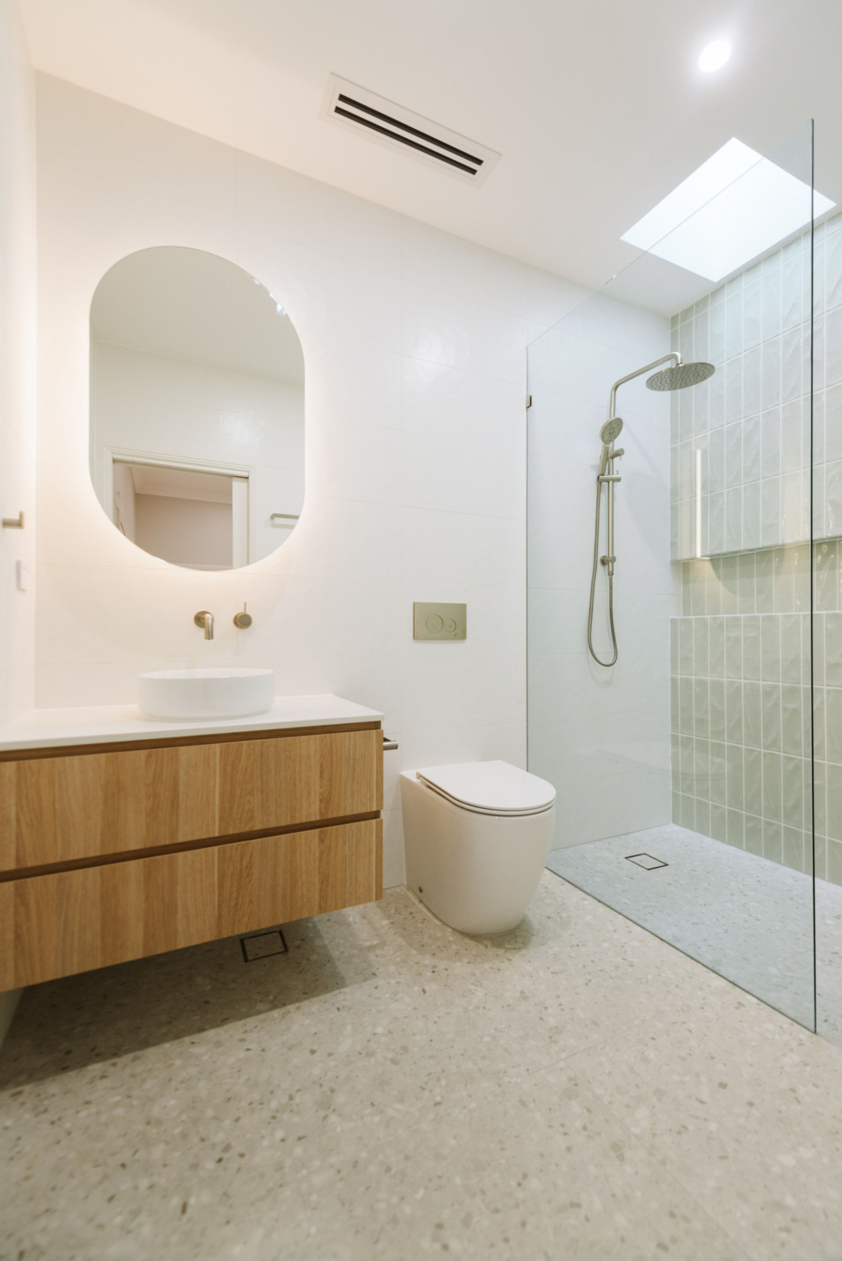 Modern ensuite with vanity, toilet and shower