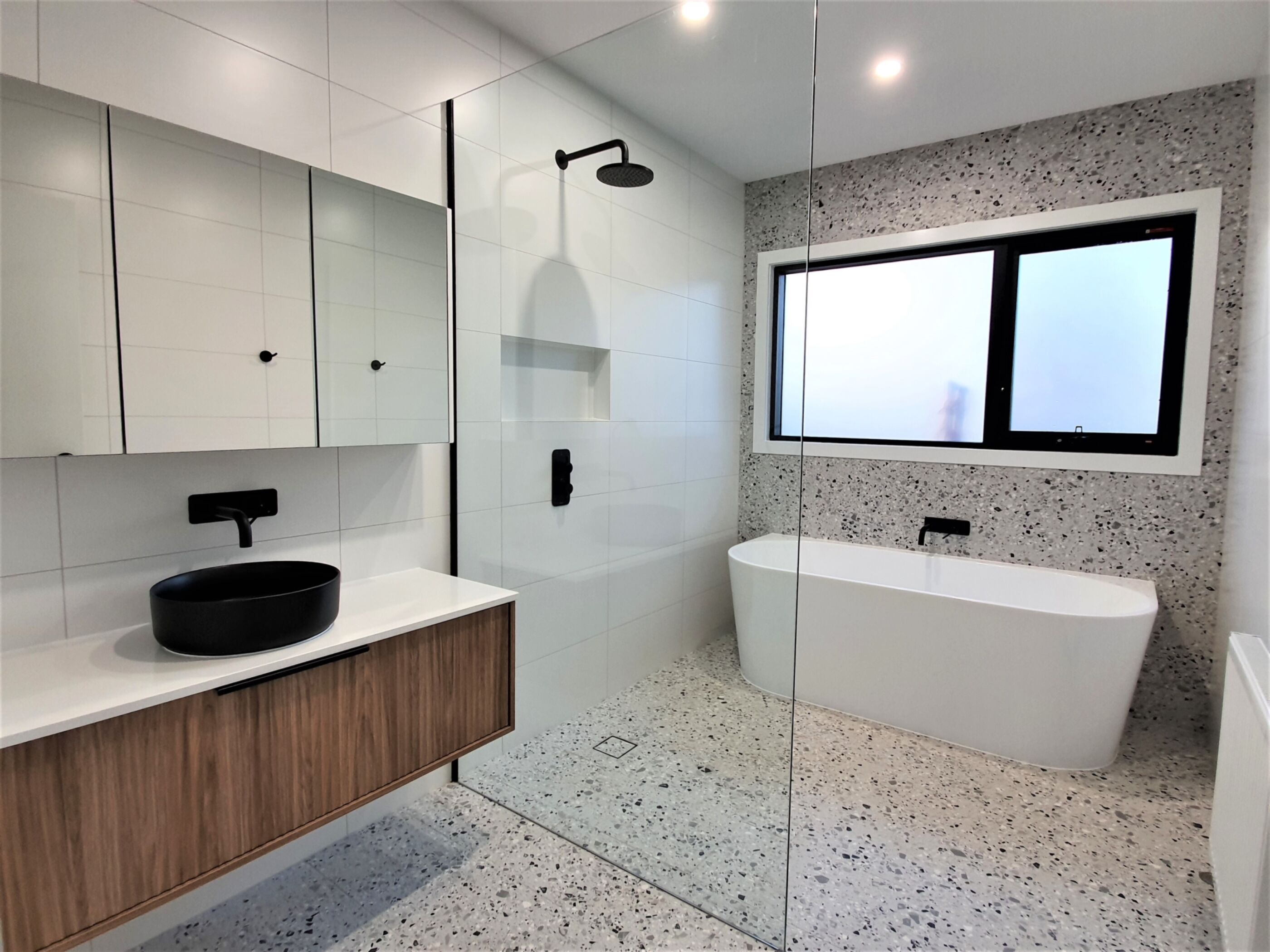 Bathroom with floating vanity, shower and free standing bath