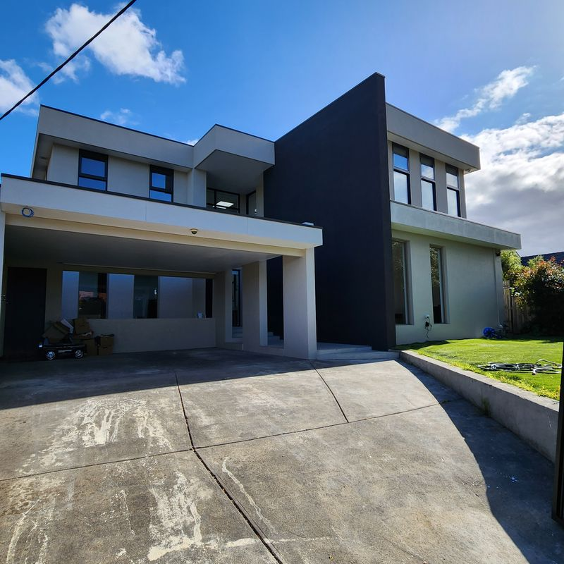 two story home with rendered walls